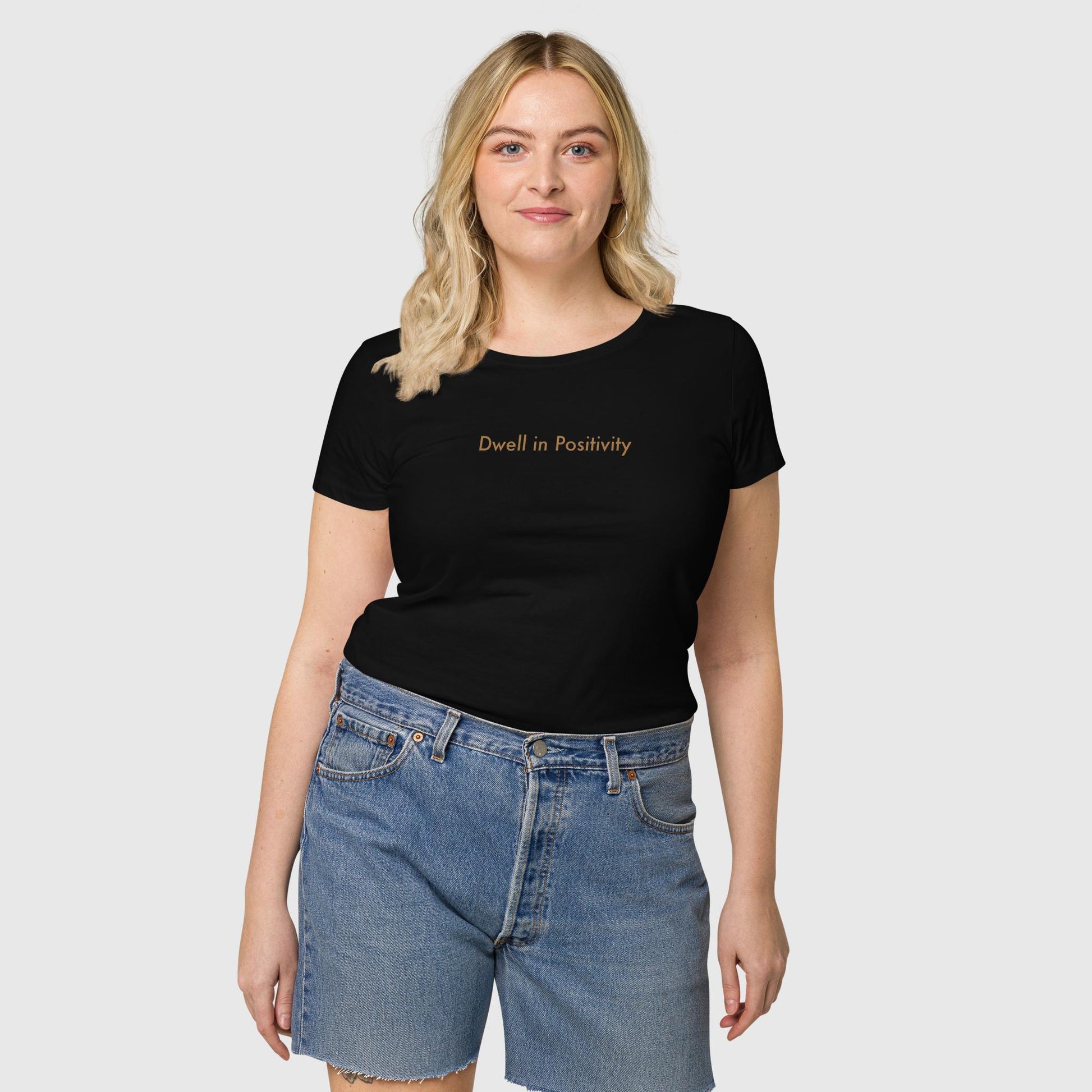 Women's black organic cotton t-shirt that features Emily Dickinson's quote, "I dwell in positivity."