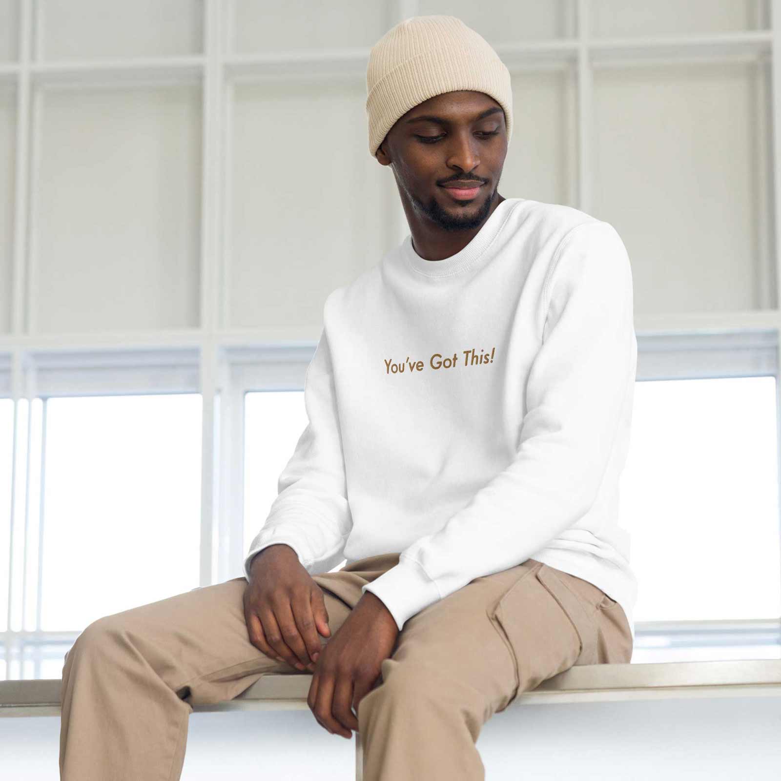 Man wearing a "You've Got This!" white sweatshirt with beanie and khaki
