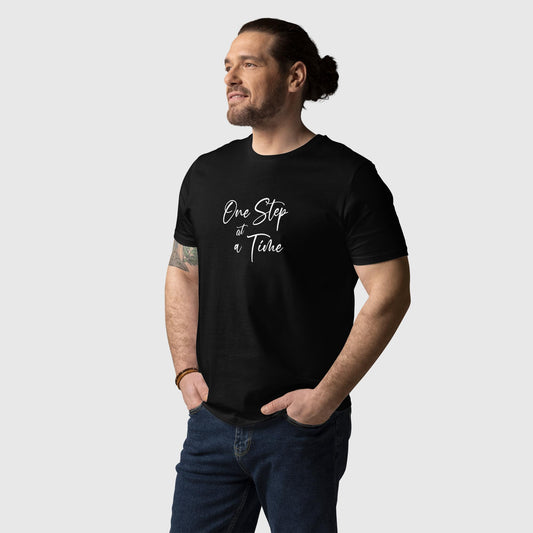 Men's black organic cotton t-shirt that features the positive saying, "One Step At A Time." 