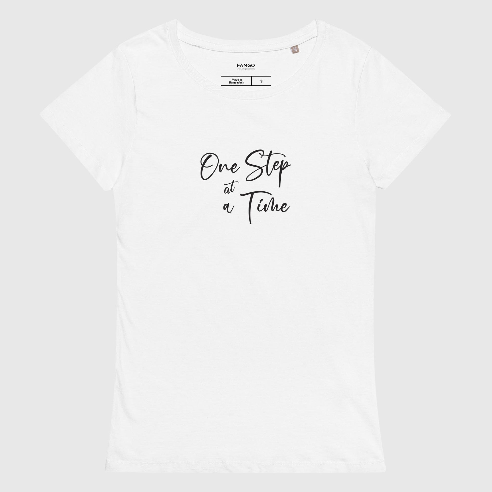 Women's white organic cotton t-shirt that features the inspirational quote, "One Step At A Time."