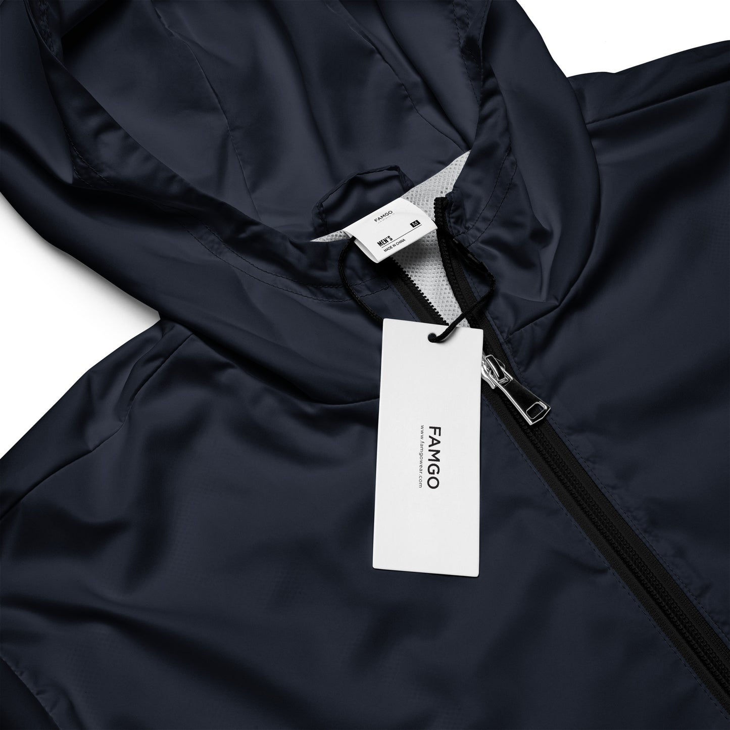 Close-up of the "Be Still" inspirational quote water-resistant windbreaker jacket with FAMGO label